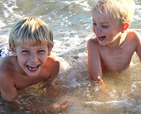 Boys playing in the ocean